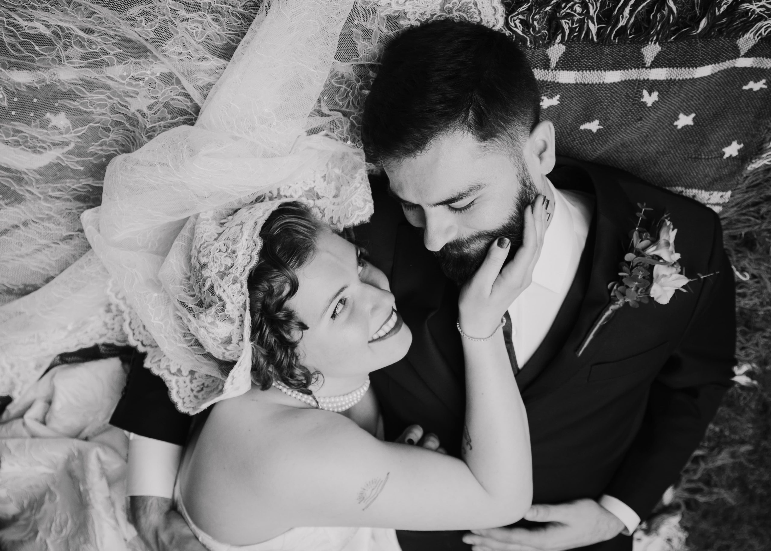 Bride and groom sharing an intimate moment in a garden courtyard, standing together in wedding attire.